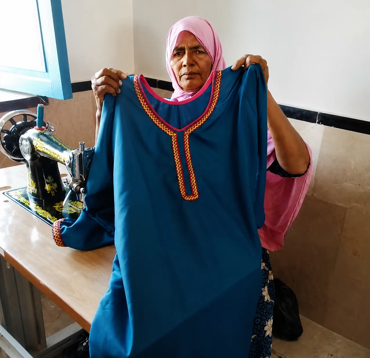 Sairah Amro displaying a garment she stitched
